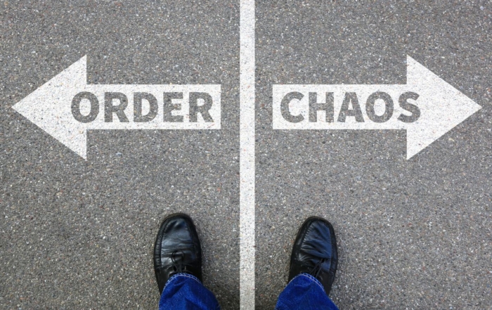 order or left pointing arrow, chaos on right pointing arrow with a person's feet standing in front of both The Importance of Intranet Governance