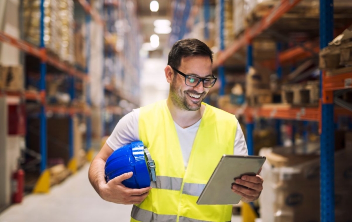 frontline manufacturing worker looking at tablet with a sharePoint intranet